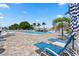 Outdoor community pool area with lounge chairs and umbrellas, perfect for enjoying sunny days at 4415 96Th N Ave, Pinellas Park, FL 33782