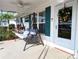 Inviting front porch with a swing, seasonal wreath, and well-maintained landscaping at 4415 96Th N Ave, Pinellas Park, FL 33782