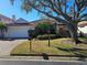 Single-story home with red tile roof, white walls, and landscaped yard at 4827 Queen Palm Ne Ter, St Petersburg, FL 33703