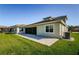 House exterior showcasing a patio and well-maintained lawn at 8319 Swiss Chard Cir, Land O Lakes, FL 34637