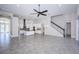 Open concept living space, connecting the kitchen to living area, with sleek flooring and modern staircase at 8319 Swiss Chard Cir, Land O Lakes, FL 34637