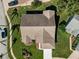 Overhead view of the home showing the roof, landscaping, driveway, and surrounding neighborhood at 8949 Bay Pointe Ct, Hudson, FL 34667