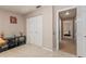 Neutral bedroom with carpet, modern wall art, and double door closet at 8949 Bay Pointe Ct, Hudson, FL 34667