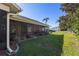 A spacious screened porch extends from this home into the backyard, surrounded by beautiful landscaping at 8949 Bay Pointe Ct, Hudson, FL 34667