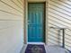 Teal front door with a welcome mat, showcasing curb appeal at 9100 Dr Martin Luther King Jr N St # 516, St Petersburg, FL 33702