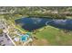 Panoramic aerial shot of park with a picturesque lake, walking path, and splashpad at 13608 S Village Dr # 6203, Tampa, FL 33618