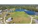 Beautiful aerial shot of community park featuring sprawling green space, lake, bridge, and recreational area at 13608 S Village Dr # 6203, Tampa, FL 33618