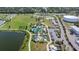 Expansive aerial view of community park featuring playground, splashpad, walking trails, and water access at 13608 S Village Dr # 6203, Tampa, FL 33618