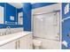 Bright blue bathroom featuring a shower-tub combination and white vanity at 13608 S Village Dr # 6203, Tampa, FL 33618