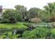 Landscaped grounds with a wooden footbridge over a pond at 14130 Rosemary Ln # 2102, Largo, FL 33774