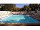 Community swimming pool with surrounding lounge chairs at 14130 Rosemary Ln # 2102, Largo, FL 33774