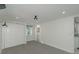 Bright bedroom with grey carpet, double closet, and view of a bathroom at 1428 Illinois Ave, Palm Harbor, FL 34683