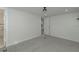 Spacious bedroom with grey carpet and access to bathroom and kitchen at 1428 Illinois Ave, Palm Harbor, FL 34683