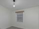 Simple bedroom with grey carpet and window at 1428 Illinois Ave, Palm Harbor, FL 34683