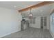 Open concept dining area with wood beams and grey flooring at 1428 Illinois Ave, Palm Harbor, FL 34683