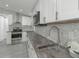 Modern kitchen with hexagon tile backsplash and concrete countertops at 1428 Illinois Ave, Palm Harbor, FL 34683