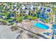 Aerial view of beachside community with pool and lush landscaping at 2100 Gulf Blvd # 13, Belleair Beach, FL 33786