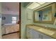 Well-appointed bathroom with a vanity, mirror, and access to the bedroom at 4452 Weybridge St # 74, Sarasota, FL 34235