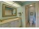 Clean bathroom with a vanity, large mirror and shower/tub combo at 4452 Weybridge St # 74, Sarasota, FL 34235