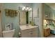 Bathroom with vanity, toilet, and linen storage at 4452 Weybridge St # 74, Sarasota, FL 34235