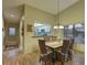 Bright dining area with wood table and wicker chairs, kitchen view at 4452 Weybridge St # 74, Sarasota, FL 34235