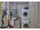 Laundry closet with washer, dryer, and extra storage at 4452 Weybridge St # 74, Sarasota, FL 34235