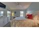 Main bedroom with light blue walls, a ceiling fan, and access to a private balcony at 4452 Weybridge St # 74, Sarasota, FL 34235