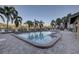 Community pool with lounge chairs and patio area at 4452 Weybridge St # 74, Sarasota, FL 34235