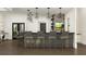 Community bar with gray barstools and modern lighting at 10876 Ibis Brook Ct, Land O Lakes, FL 34638