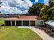 Aerial view of a single-story house with a large backyard and carport at 11224 Inglewood Dr, Gibsonton, FL 33534