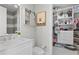 White bathroom with a built-in closet and hexagon tile floor at 1308 W Plymouth St, Tampa, FL 33603