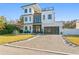 Modern two-story home with white and wood siding, blue door, and paver driveway at 1308 W Plymouth St, Tampa, FL 33603