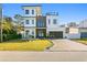 Modern two-story home with white and wood siding, blue door, and paver driveway at 1308 W Plymouth St, Tampa, FL 33603