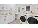 Bright laundry room with white cabinets and modern appliances at 1308 W Plymouth St, Tampa, FL 33603