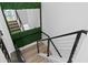 Modern staircase with metal railing and green wall feature at 1308 W Plymouth St, Tampa, FL 33603