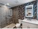 Bathroom with a glass shower, floral wallpaper, and modern vanity at 132 Mirror Lake N Dr # 404, St Petersburg, FL 33701