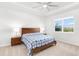 This bedroom has a ceiling fan, and large window for natural light at 17977 Grand Prosperity Dr, Venice, FL 34293