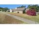 House with a side yard showcasing vibrant pink flowers at 2308 Long Green Ct, Valrico, FL 33596