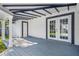 Covered back patio with wood-look flooring and French doors at 4901 W Bartlett Dr, Tampa, FL 33603