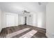 Bright bedroom with hardwood floors and white closet doors at 4901 W Bartlett Dr, Tampa, FL 33603