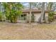 Exterior backyard view of home featuring mature landscaping, a patio, and glass sliding doors at 5110 28Th W St, Bradenton, FL 34207