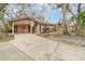 Single-story home with covered carport, manicured lawn, and mature trees in a tranquil setting at 5110 28Th W St, Bradenton, FL 34207