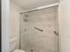 Close up of the remodeled shower with designer tile, shower head and upgraded glass at 5110 28Th W St, Bradenton, FL 34207