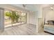 Sun-drenched room with large sliding glass doors and wood-look floors overlooking lush greenery at 5110 28Th W St, Bradenton, FL 34207