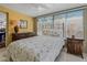 Bright bedroom with floral bedding, dresser, and nightstand at 1957 Temple Ter, Clearwater, FL 33764