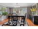Bright dining room with hardwood floors, farmhouse table and chairs, and large windows at 1957 Temple Ter, Clearwater, FL 33764