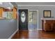 Interior entry with hardwood floors and view of kitchen at 1957 Temple Ter, Clearwater, FL 33764