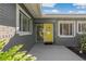 Front entrance with yellow door and brick facade at 1957 Temple Ter, Clearwater, FL 33764
