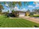 Ranch-style home with a large grassy yard at 1957 Temple Ter, Clearwater, FL 33764
