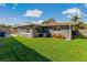House exterior with lush green lawn at 1957 Temple Ter, Clearwater, FL 33764